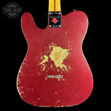 Red electric guitar with gold design on a black background, featuring 'Tone Shop' branding.