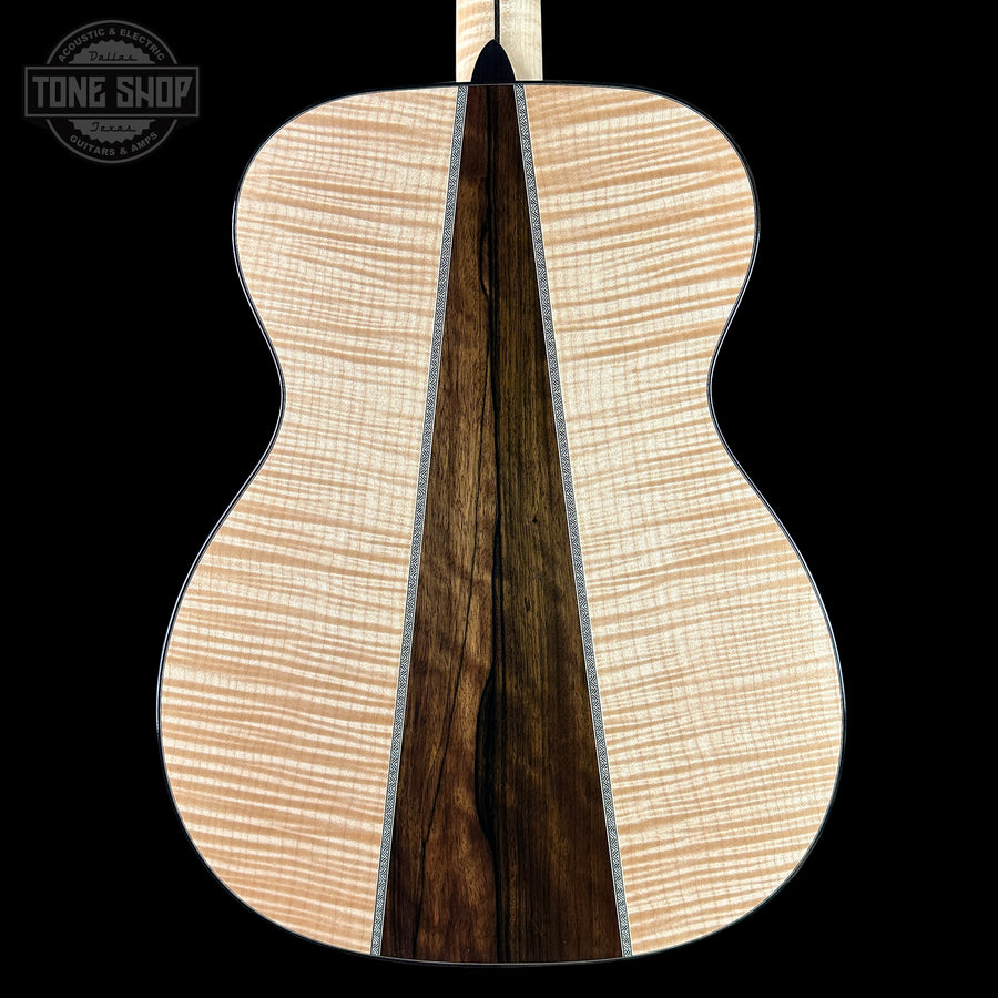 Maple and walnut back and sides of a Martin guitar on a black background.