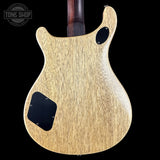 Back of a guitar with a 'Tone Shop' logo in the corner