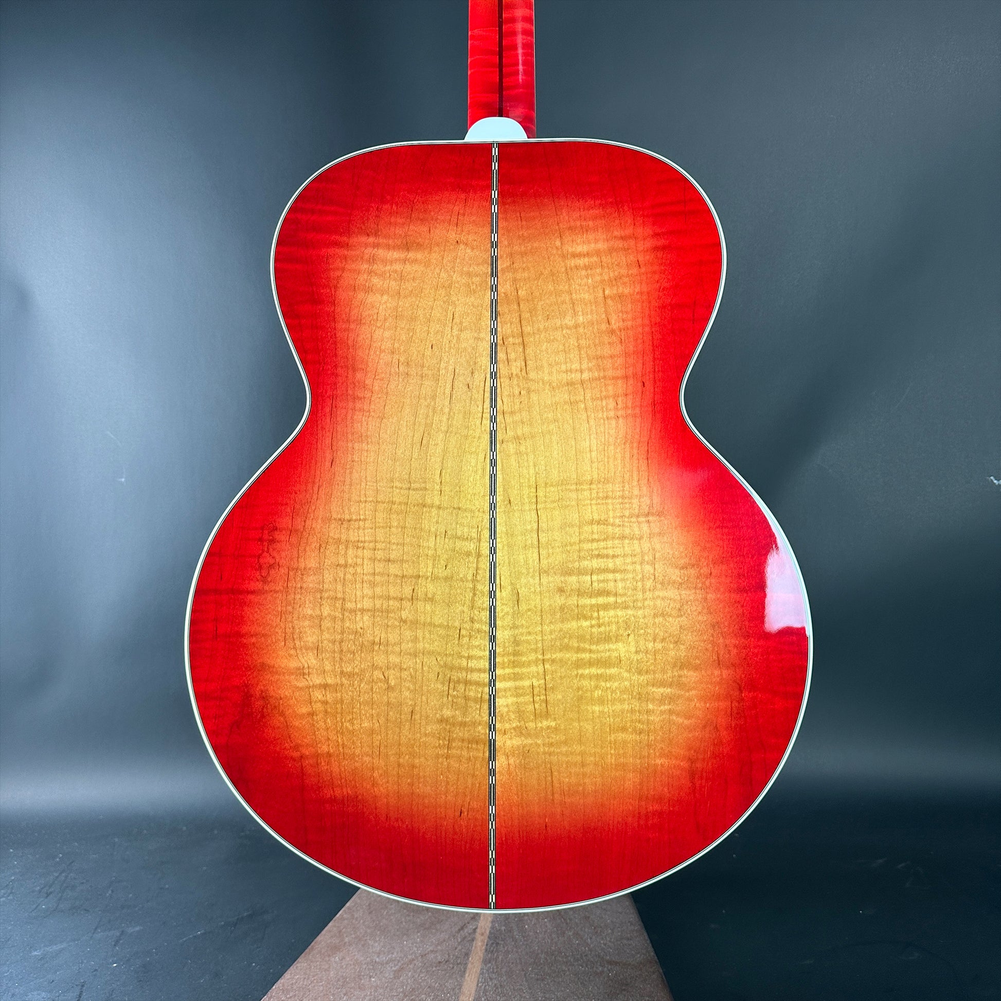 Acoustic guitar with a red and orange gradient on a dark background