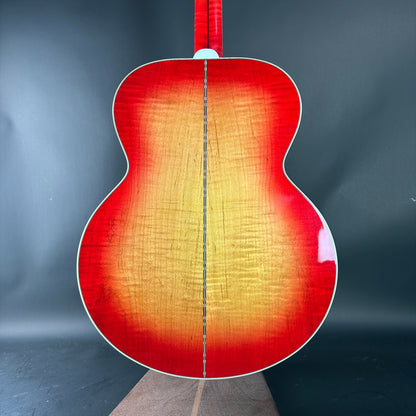 Acoustic guitar with a red and orange gradient on a dark background