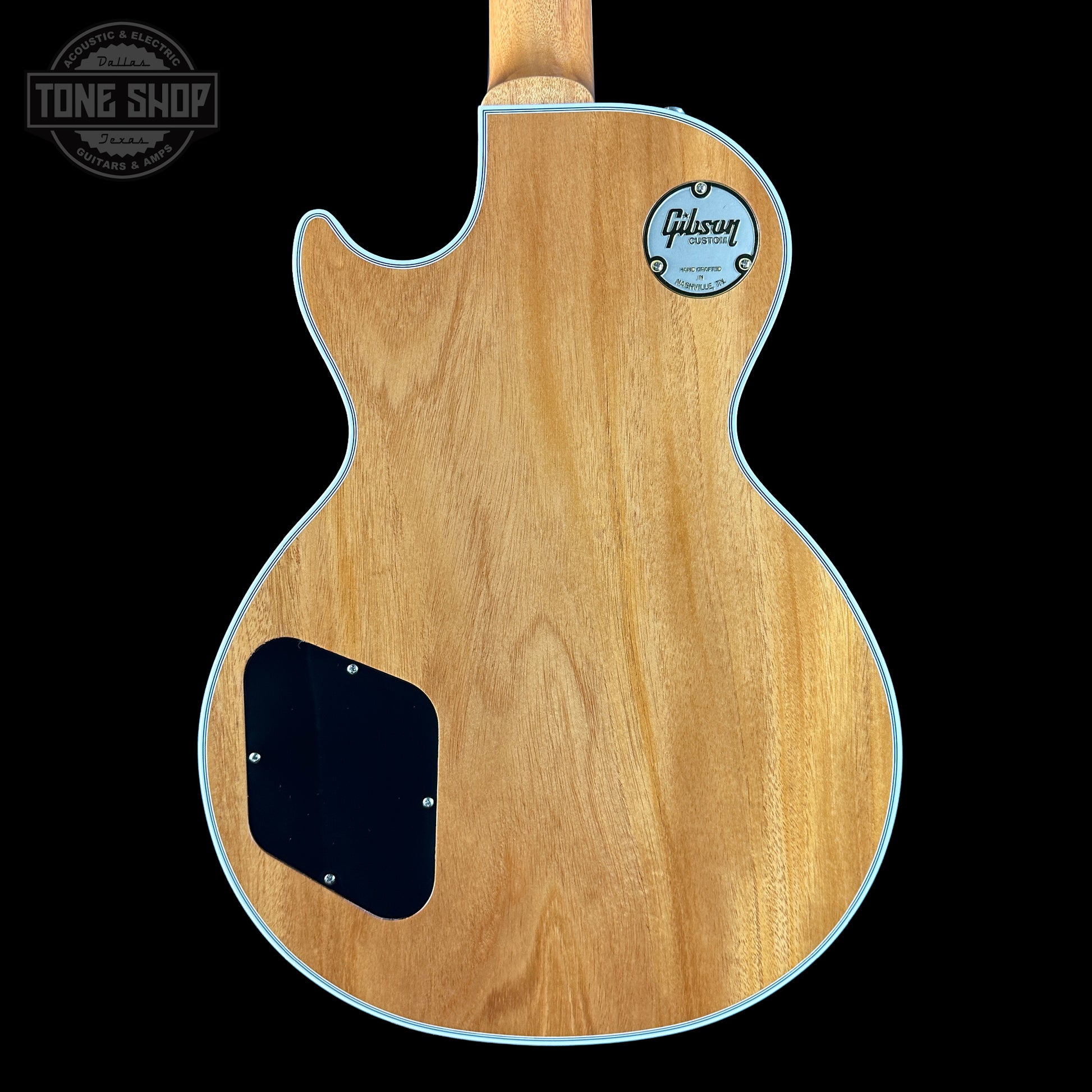 Back view of a Gibson electric guitar with a visible brand logo on a black background.