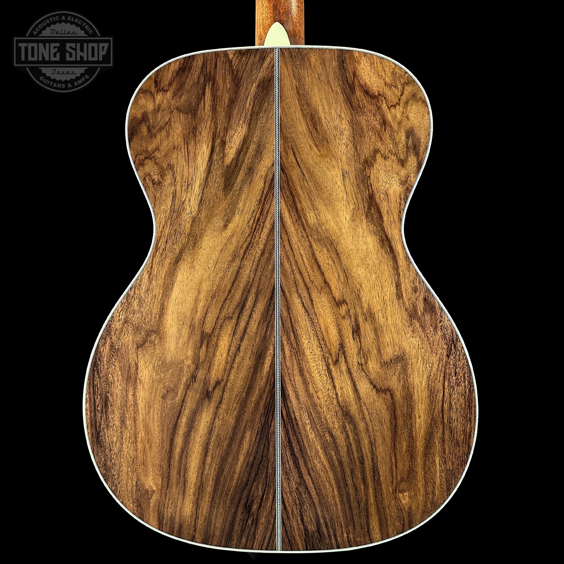 Wooden acoustic guitar back with 'Tone Shop' logo in the corner.