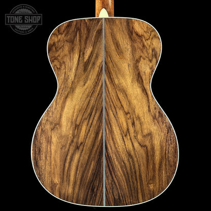 Wooden acoustic guitar back with 'Tone Shop' logo in the corner.