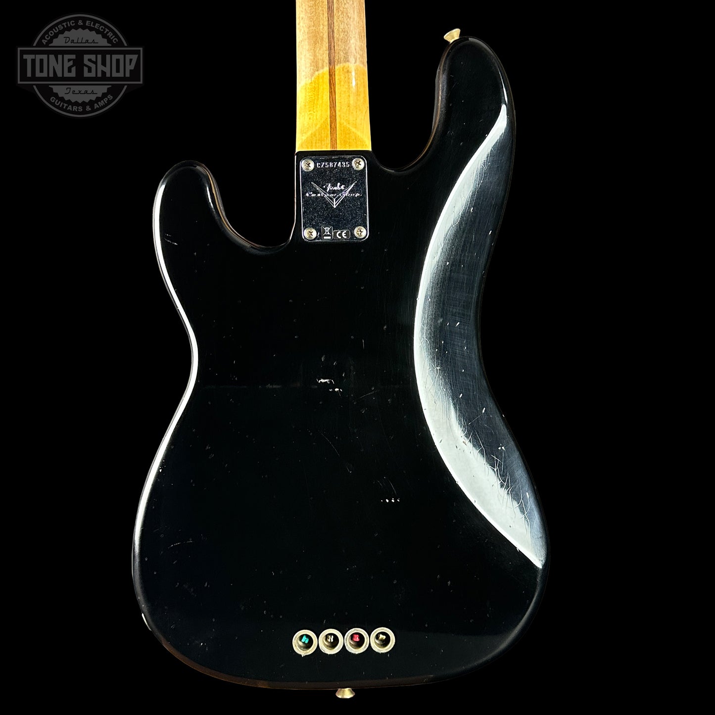 Black electric guitar with a visible brand logo on a black background