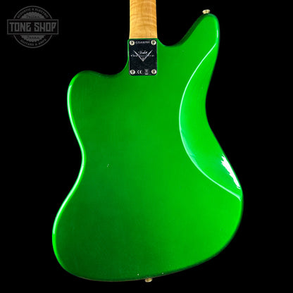 Green electric guitar with a visible brand logo on a black background