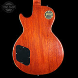 Back view of a Gibson electric guitar with a visible brand logo on a black background.