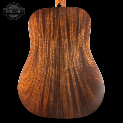 Close-up of a wooden acoustic guitar body with 'Tone Shop' logo.