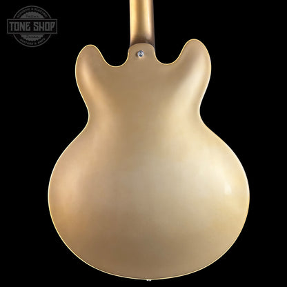 Gold electric guitar body on a black background with 'Tone Shop' logo.