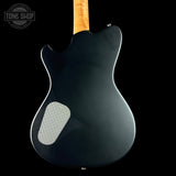 Back view of a black electric guitar with a visible brand logo in the corner.