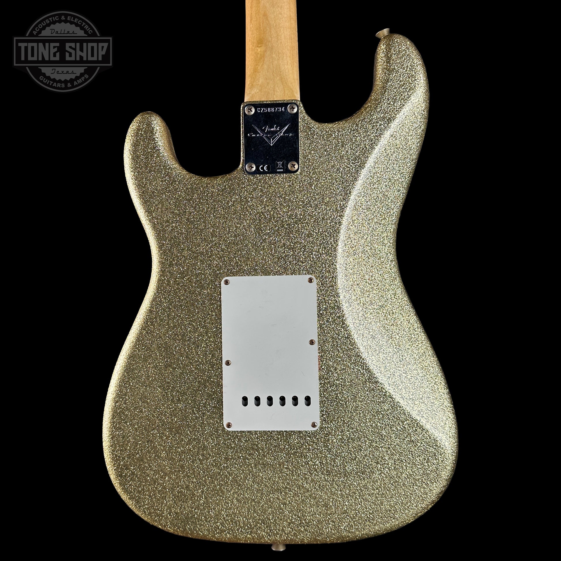 Guitar body with glittery finish on a black background