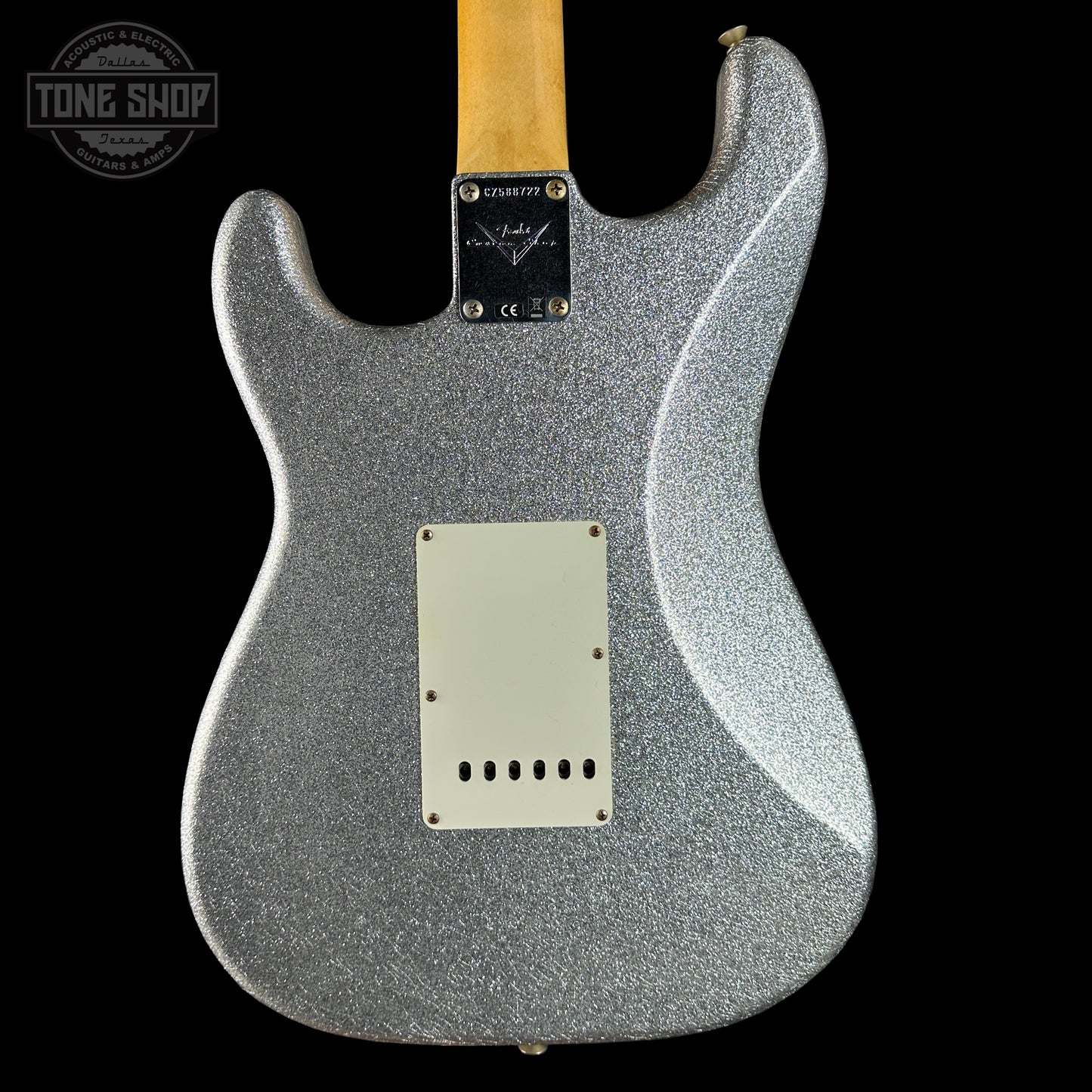 Silver glitter electric guitar with a black background