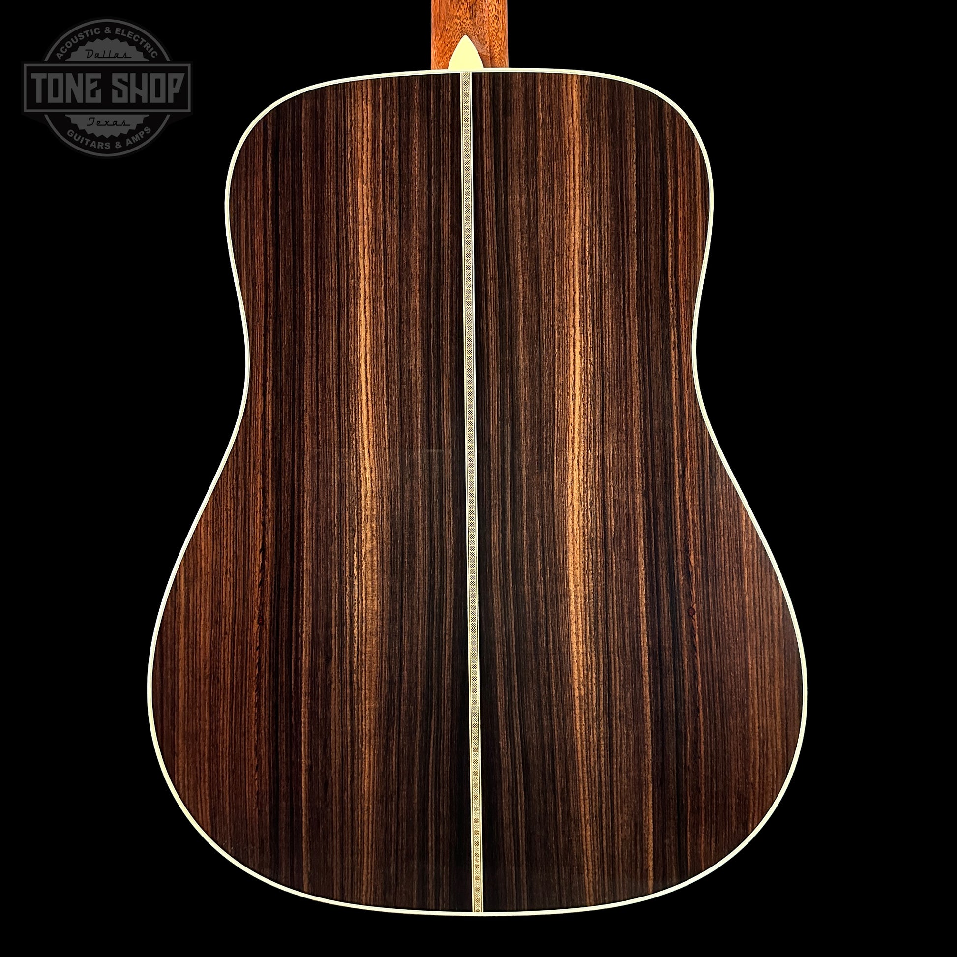 Back view of a wooden acoustic guitar with a visible brand logo in the corner.