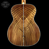 Wooden guitar back with 'Tone Shop' logo in the corner