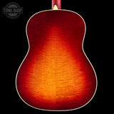 Close-up of a red acoustic guitar body with 'Tone Shop' logo.