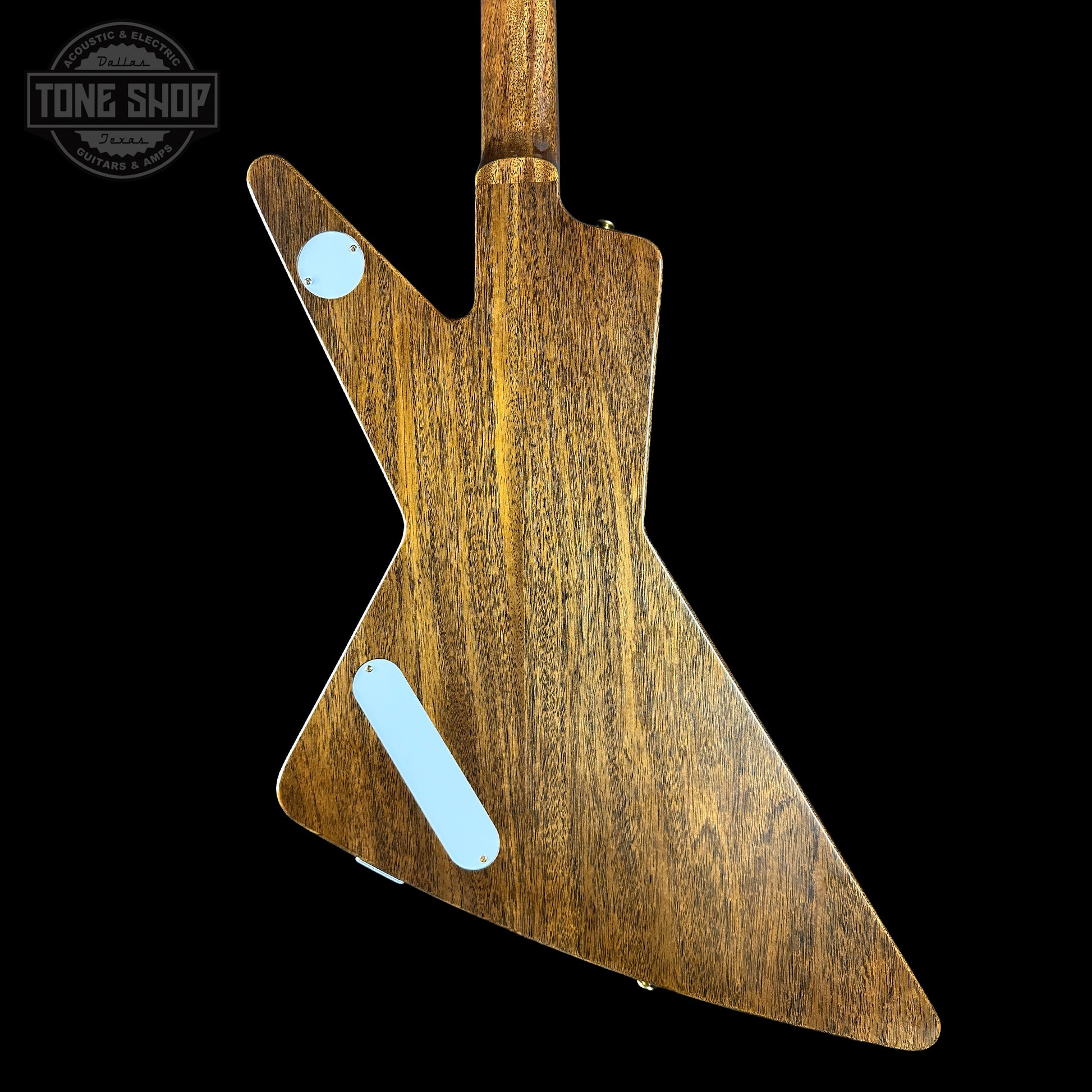 Wooden guitar body with a 'Tone Shop' logo in the corner