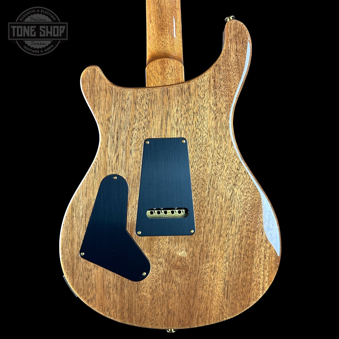 Back view of a wooden electric guitar with a visible brand logo in the corner.