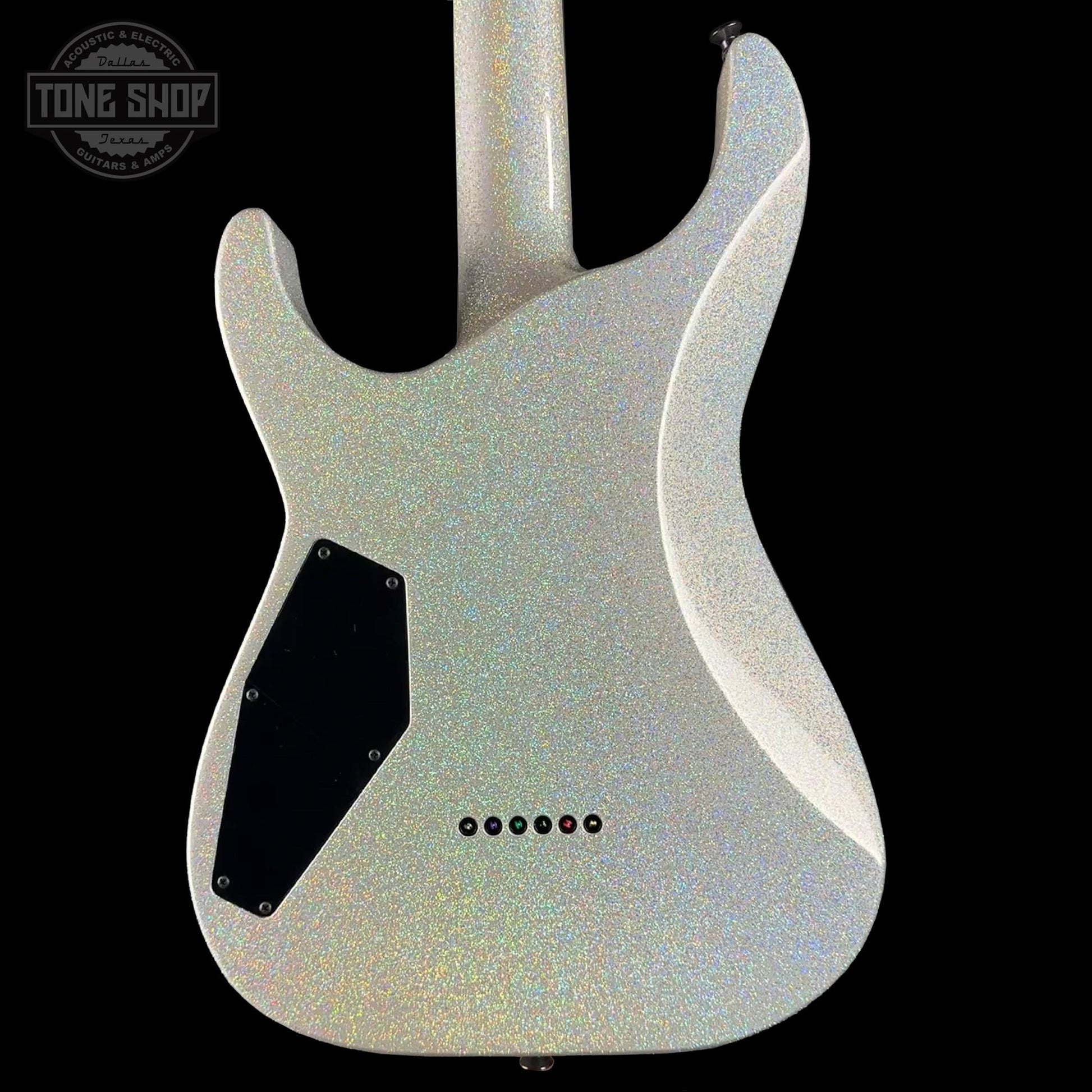 Guitar body with a glittery finish on a black background, featuring the Tone Shop logo.