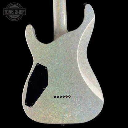 Guitar body with a glittery finish on a black background, featuring the Tone Shop logo.