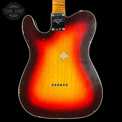 Fender electric guitar with a sunburst finish on a black background