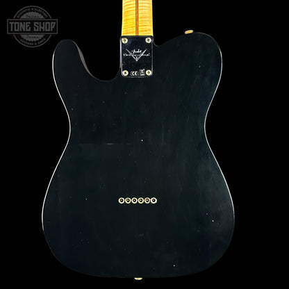 Black electric guitar body with a visible brand logo on a black background