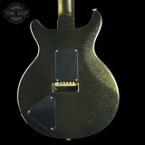 Back view of a black glitter electric guitar with 'Tone Shop' logo.