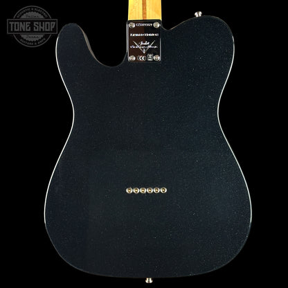 Black electric guitar body with visible brand logo on a black background