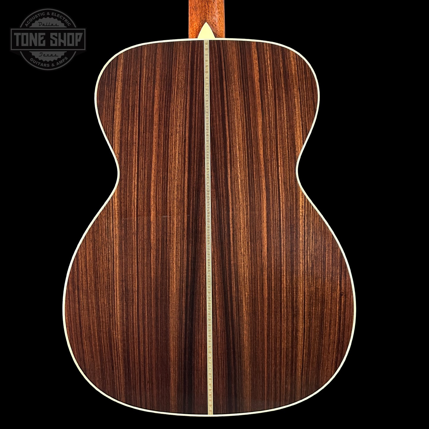 Back view of a wooden acoustic guitar with a visible brand logo in the corner.