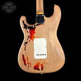 Wooden electric guitar body with abstract design on a black background, featuring the Tone Shop logo.