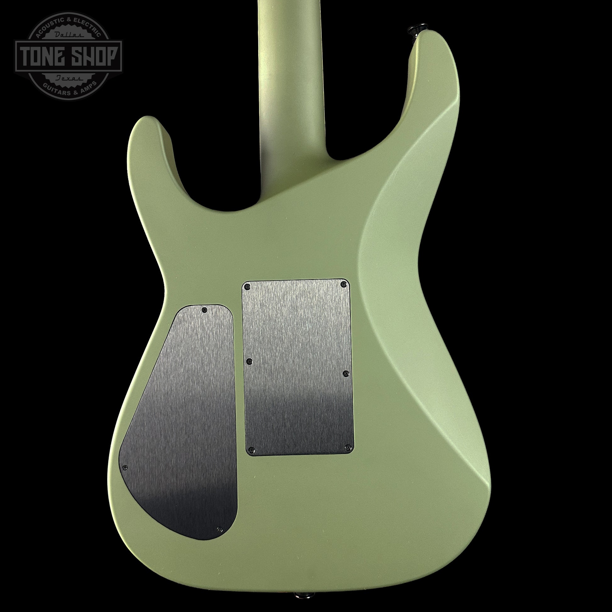 Green electric guitar body with 'Tone Shop' logo in the corner
