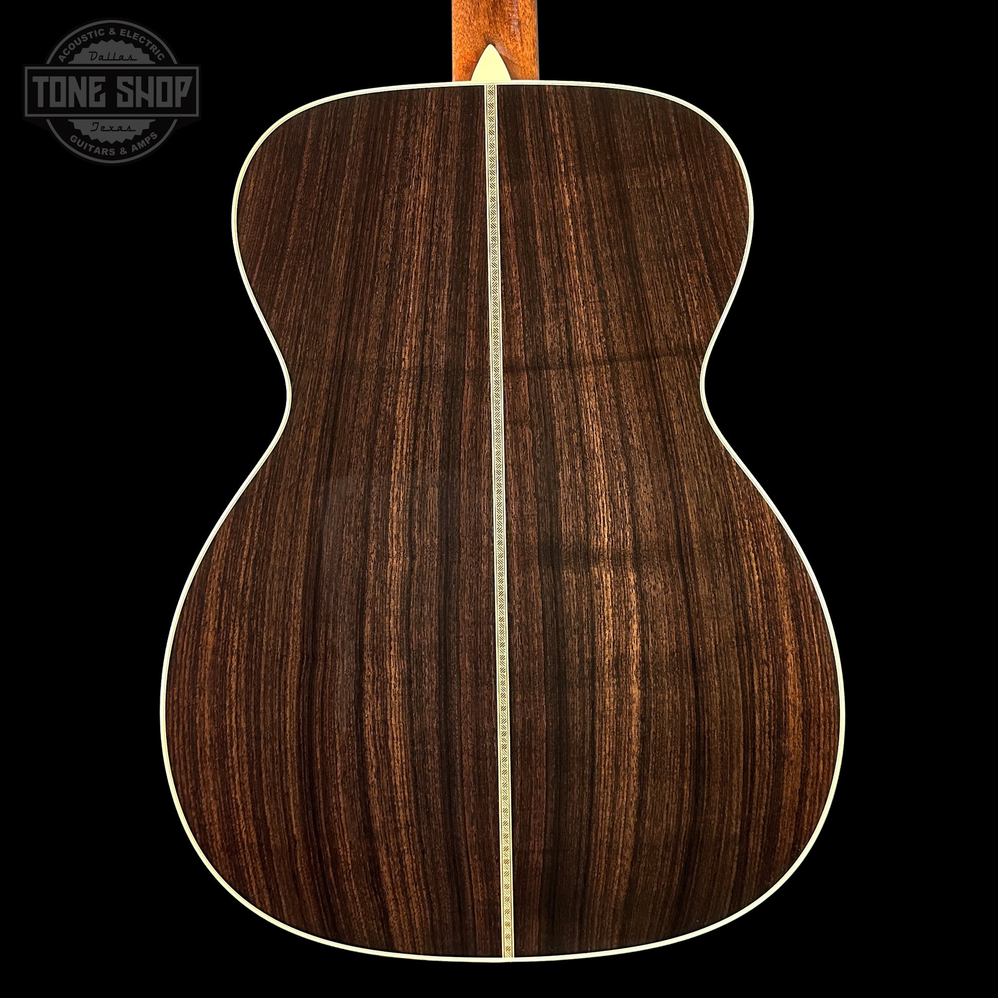 Back view of a wooden acoustic guitar with a visible brand logo in the corner.