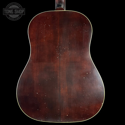 Back view of a wooden acoustic guitar with 'Tone Shop' logo.