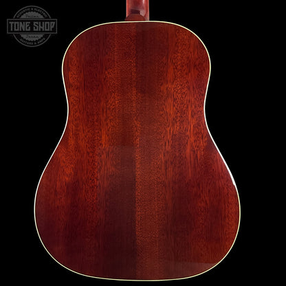 Back view of a wooden acoustic guitar with a dark brown finish on a black background.