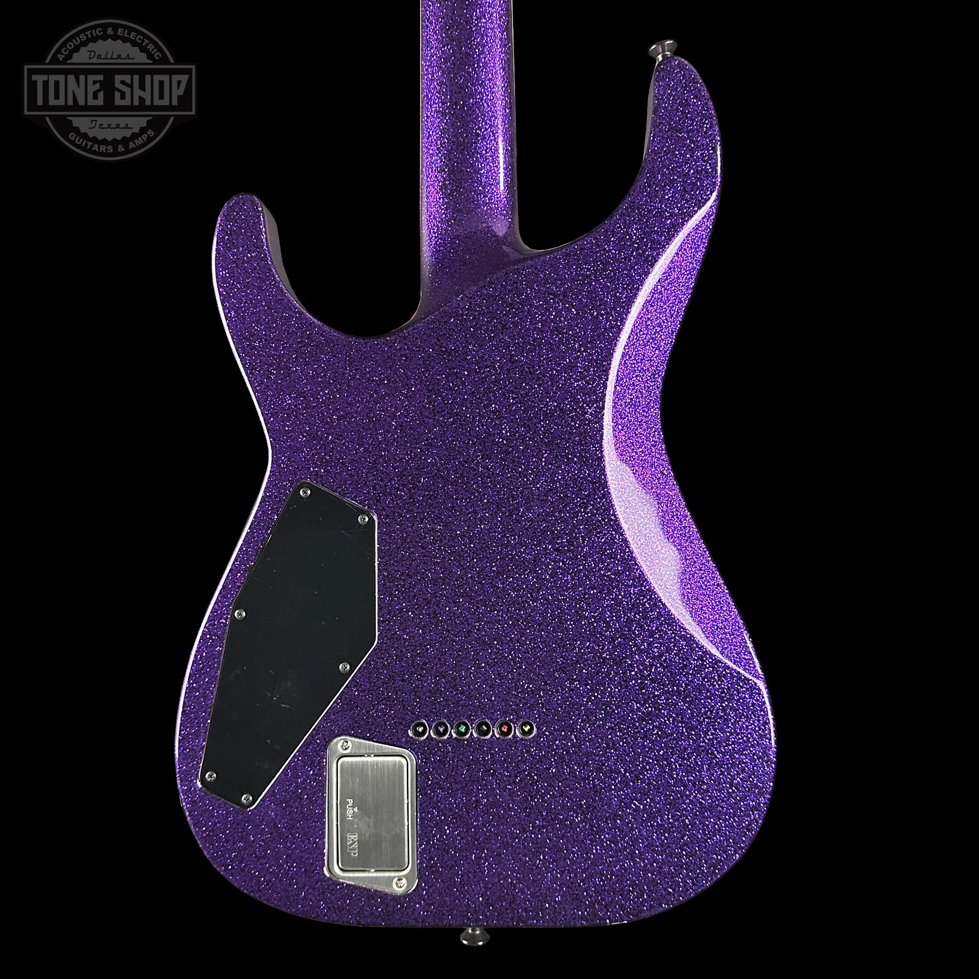 Purple glitter electric guitar body with 'Tone Shop' logo in the corner.