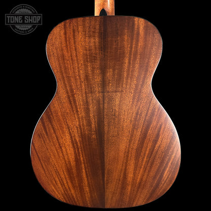 Wooden guitar back with a visible brand logo in the corner