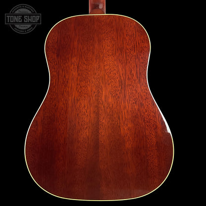 Back view of a wooden acoustic guitar with 'Tone Shop' logo in the corner.