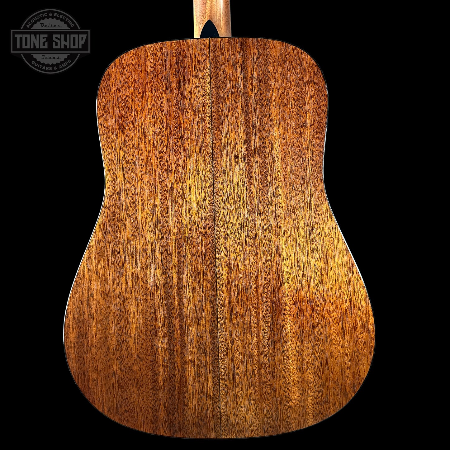 Back view of a wooden acoustic guitar with 'Tone Shop' logo in the corner.