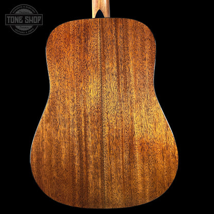 Back view of a wooden acoustic guitar with 'Tone Shop' logo in the corner.