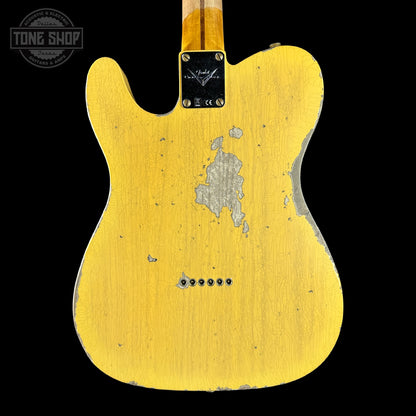Yellow electric guitar body with visible wear on a black background, featuring 'Tone Shop' logo.