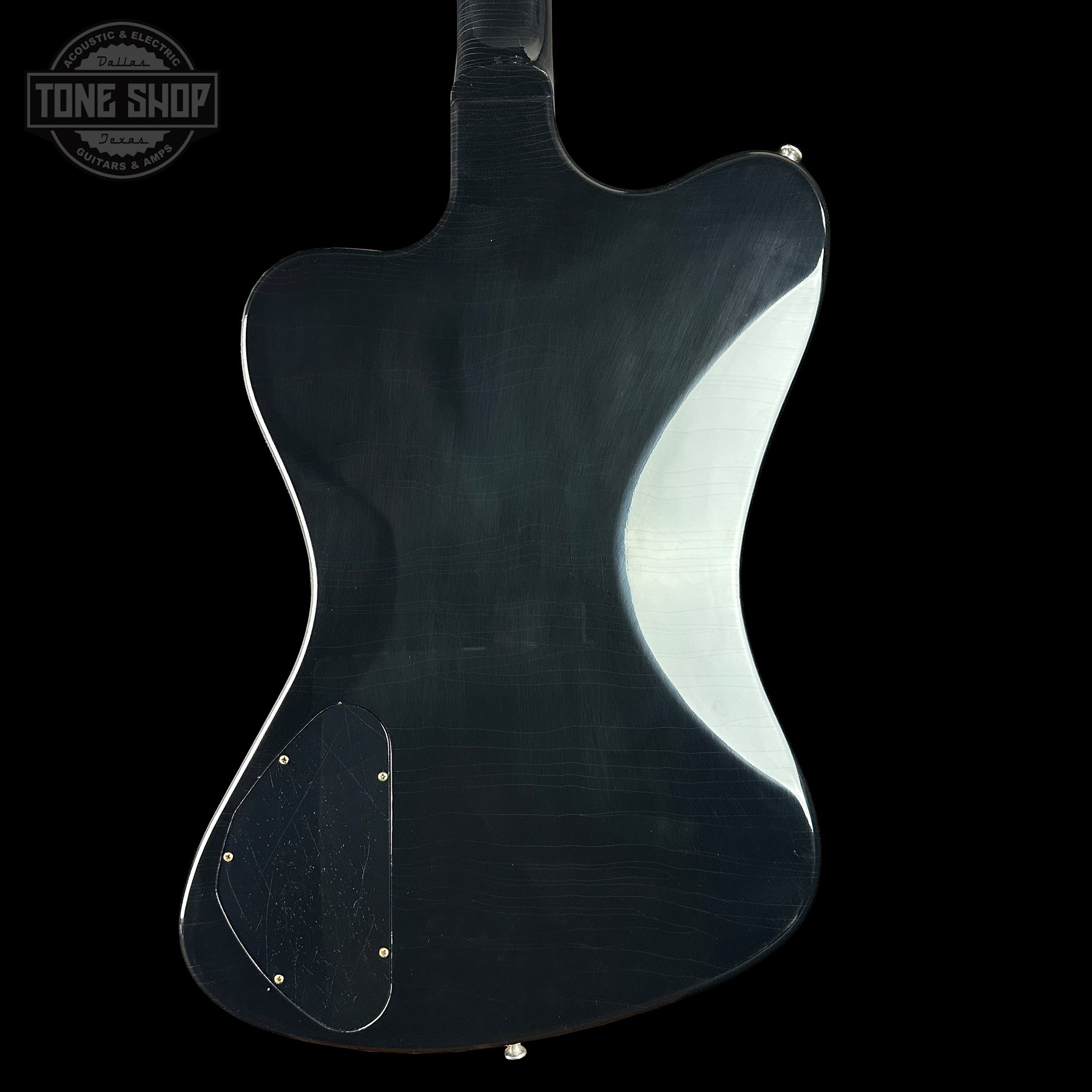 Guitar body with a glossy finish on a black background, featuring the Tone Shop logo.