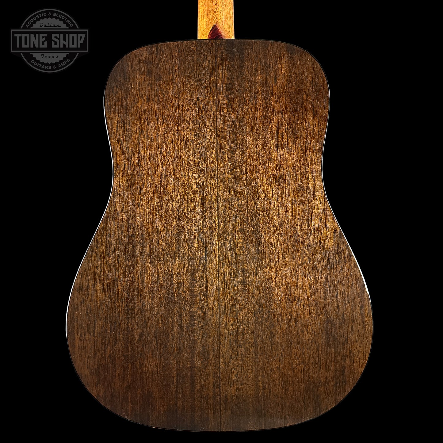 Back of a wooden acoustic guitar with 'Tone Shop' logo in the corner.