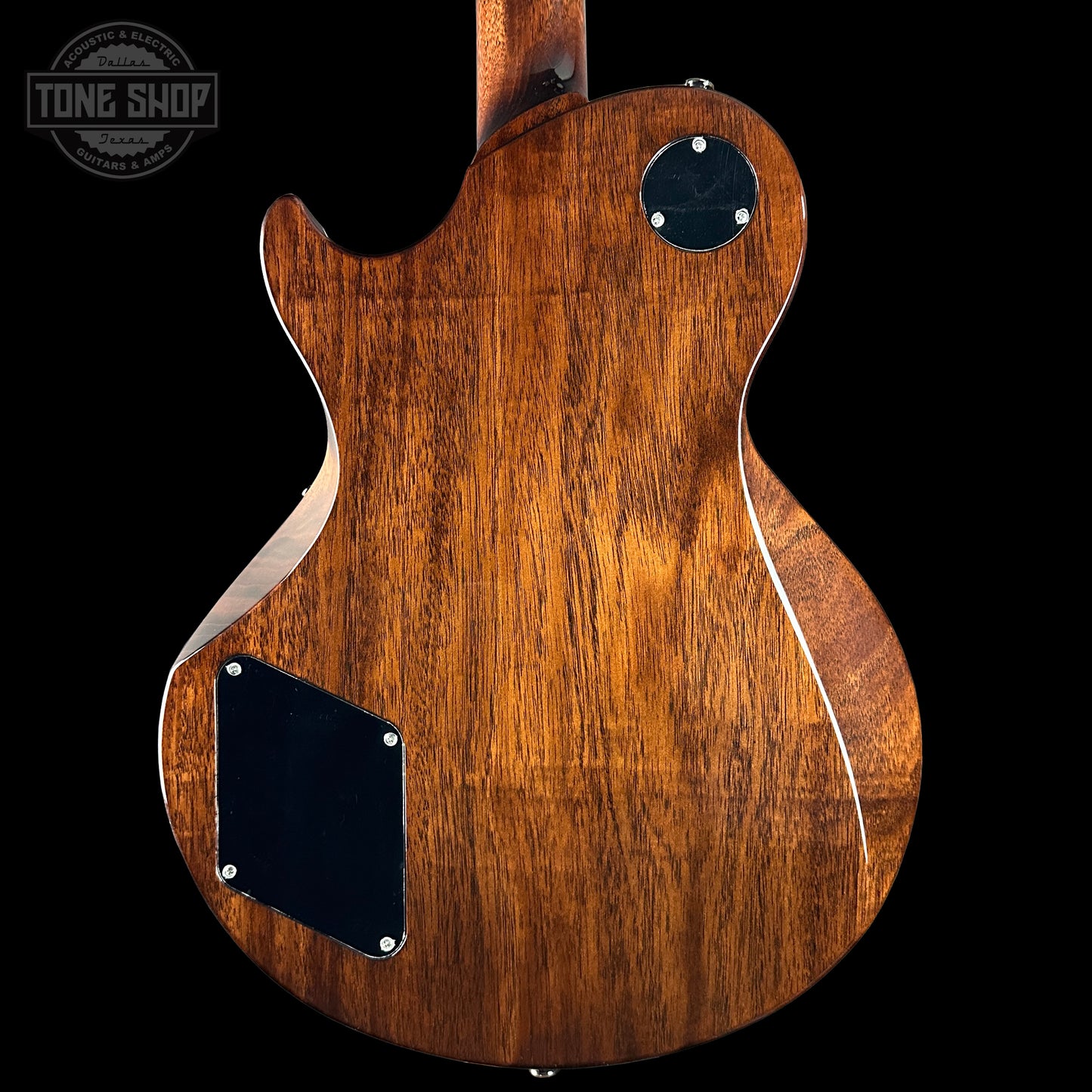 Wooden guitar body with a visible brand logo in the corner