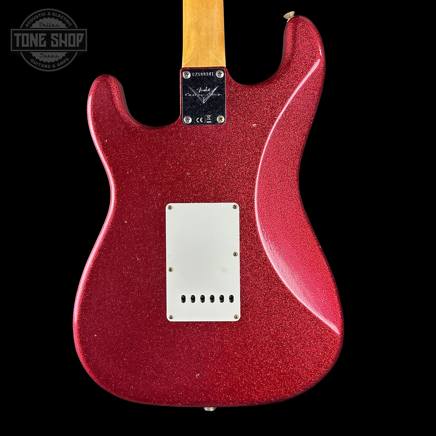 Red electric guitar body on a black background