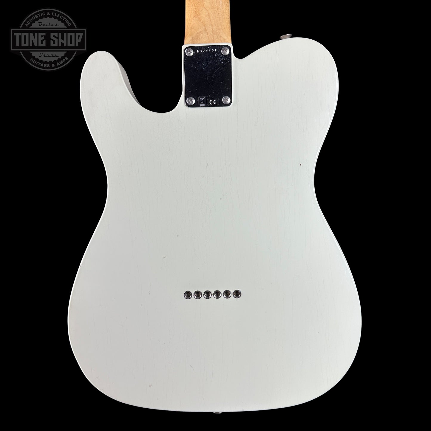 White electric guitar body on a black background