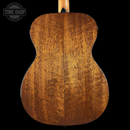 Close-up of a wooden acoustic guitar back with 'Tone Shop' logo.