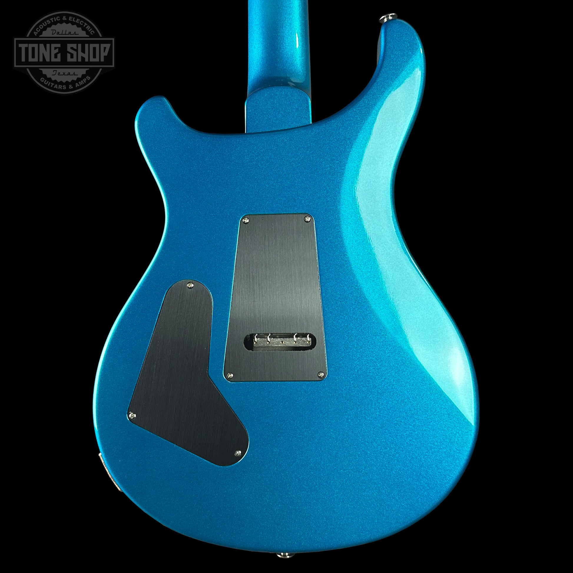 Blue electric guitar body with 'Tone Shop' logo in the corner.