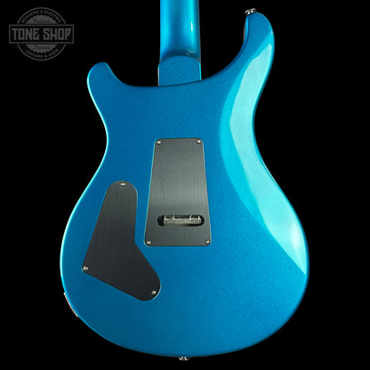 Blue electric guitar body with 'Tone Shop' logo in the corner.