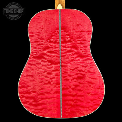 Close-up of a red guitar back with a visible brand logo in the corner.