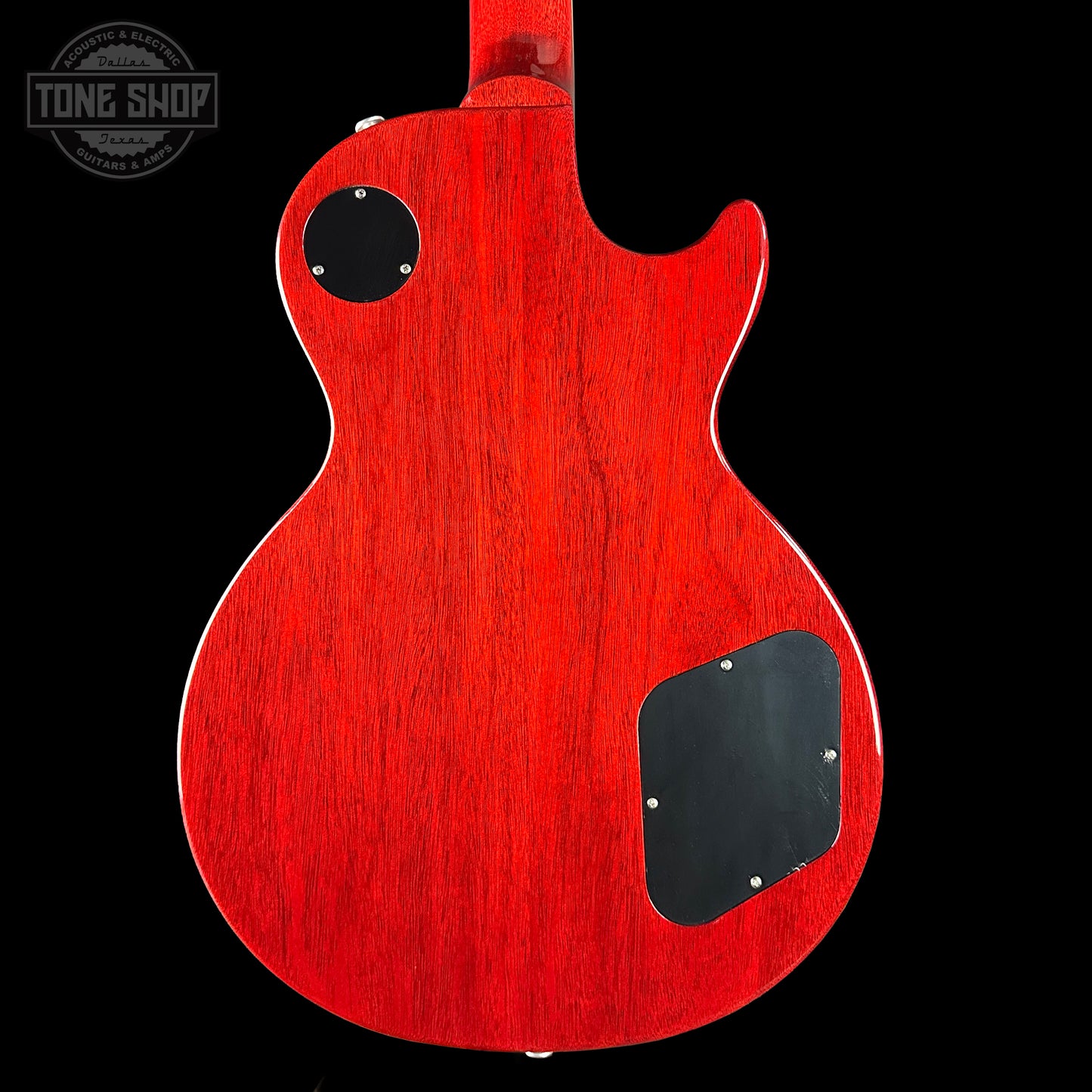 Red electric guitar body with a black pickguard on a black background, featuring 'Tone Shop' logo.