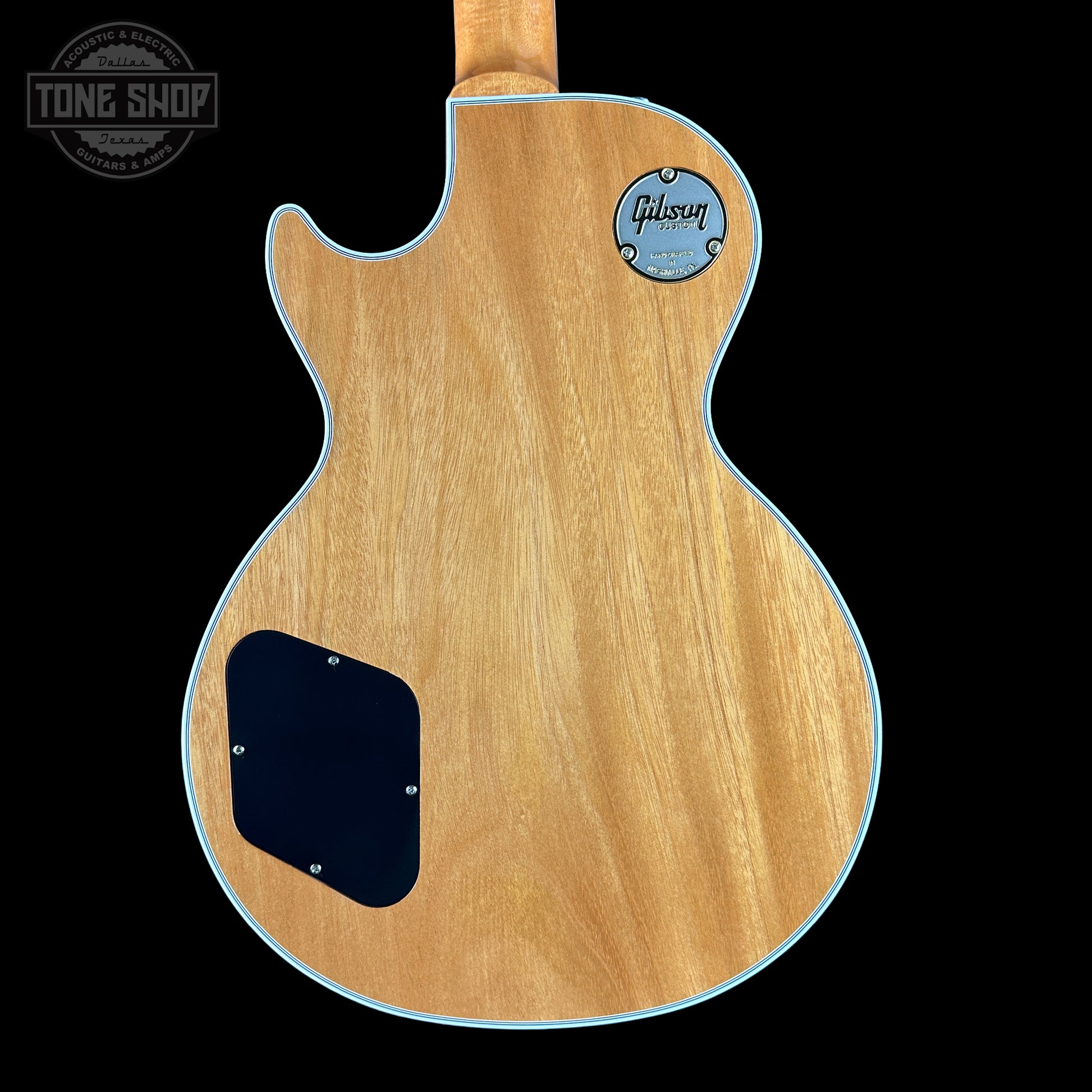 Back view of a Gibson electric guitar with 'Tone Shop' logo.